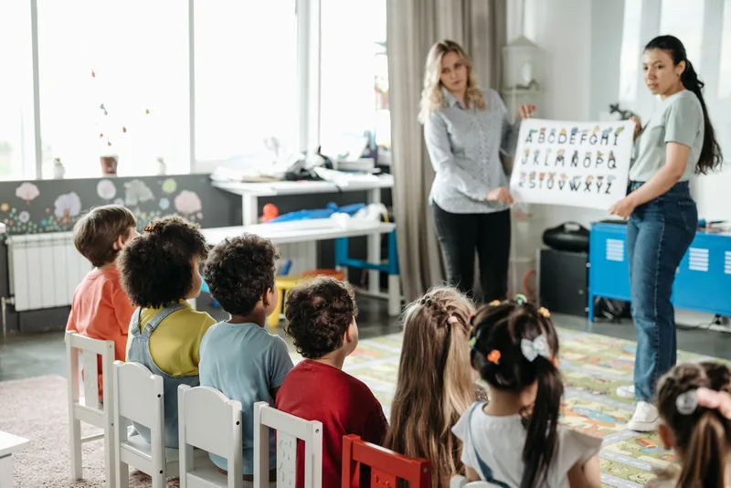 Children sitting in a circle during a kindergarten lesson