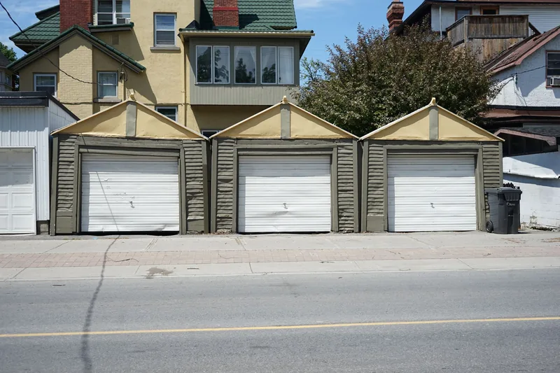 Row of residential garages with white garage doors
