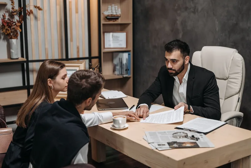 Lawyer reviewing legal documents with clients at a desk