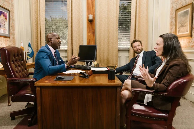 Attorneys and a client in a consultation meeting