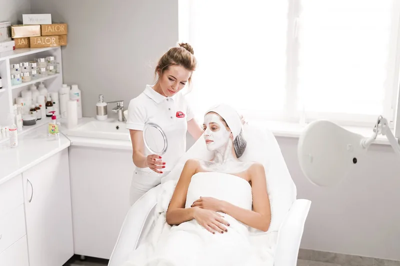 Beautician showing a client her skin-care results