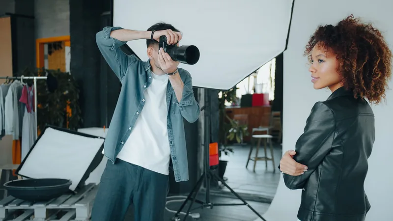 Photographer shooting a model with a softbox light