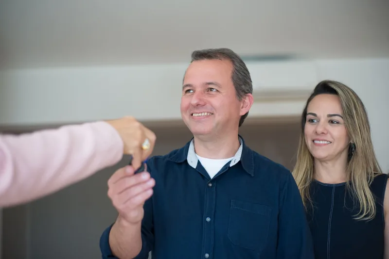 Couple receiving house keys from their agent