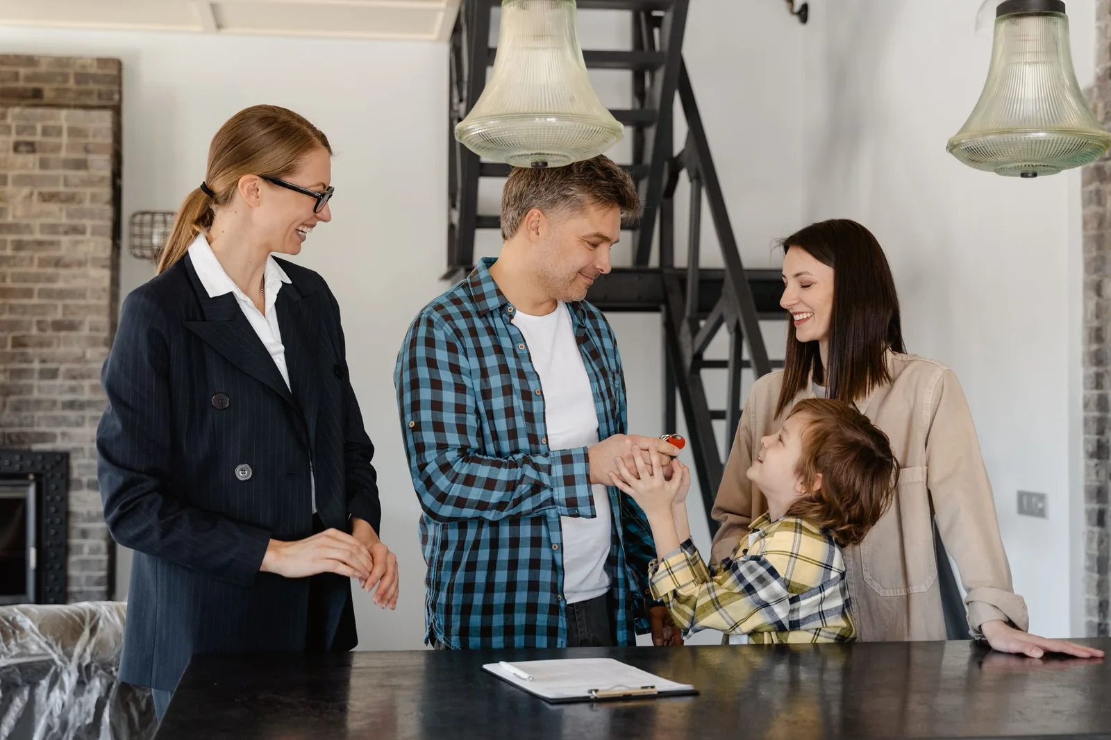 Real estate agent welcoming a family into a new home